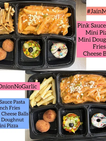 A modern Jain meal box perfect for kids and adults alike. This one includes my popular pink sauce pasta, mini pizzas, cheese balls, and fries, all made without any onion or garlic.