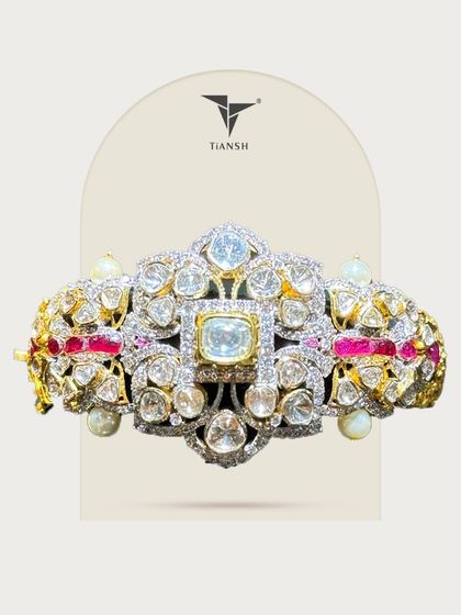 This Polki kada is a piece of wearable art. Uncut diamonds shimmer like ancient stars, nestled in a dance of gold, ruby, and pearls. Every curve echoes royalty, and every detail whispers heritage.