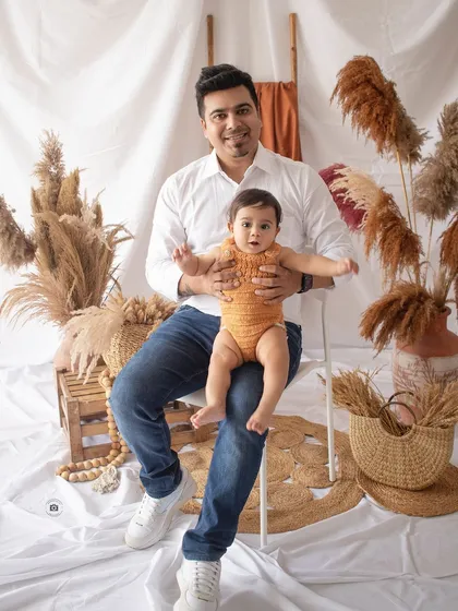 A proud dad with his little one. This portrait, set against our boho backdrop, is a wonderful keepsake of this special time.