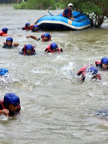 Participants practice essential safety drills, learning how to swim and move in the river current next to the raft. Safety training is a core component of all our water sports courses.
