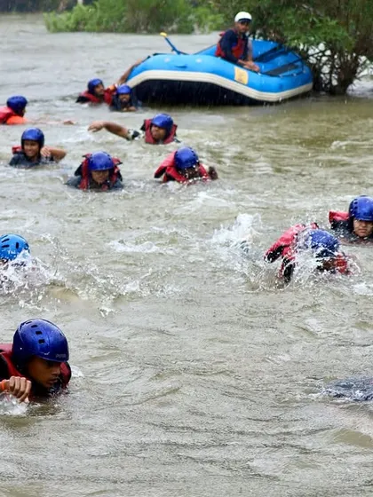 Participants practice defensive swimming techniques during a safety drill, learning how to navigate the current on their own.
