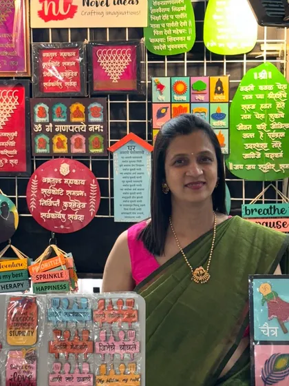 All set to meet my customers in Bangalore. A photo of me at my stall at the White Housse, HSR Layout, surrounded by my colorful creations.