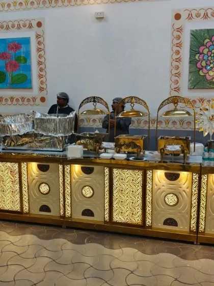 Our team managing a large, illuminated live cooking station. This setup is perfect for big events, allowing multiple chefs to serve a variety of dishes simultaneously.