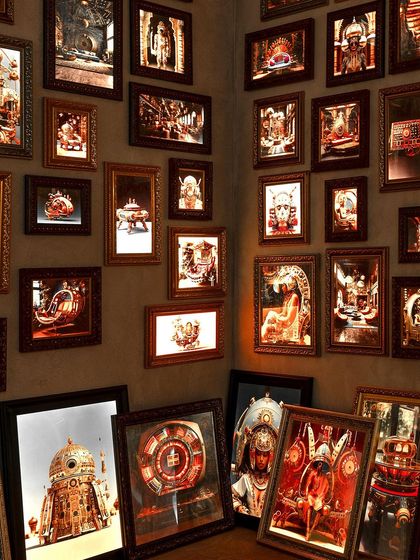 A retro-futuristic photo gallery from our 'Indofuturism' installation. The wall is filled with AI-generated images that blend traditional Indian motifs with futuristic concepts, creating a surreal panorama.