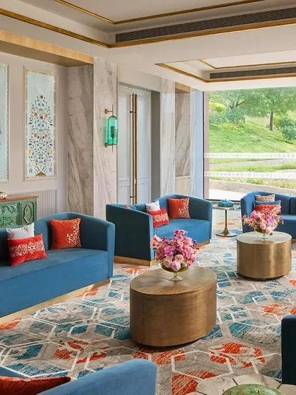This lounge area at Taj Devi Ratn overlooks the Aravalli hills, and I designed it to feel like a royal court. Deep blue sofas, traditional Indian art panels, and custom carpets create a space that is both regal and inviting, perfect for conversation and relaxation.