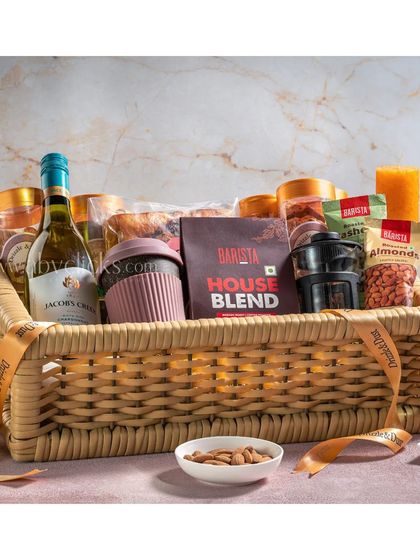 A luxurious wicker gift basket from Drizzle & Dust, featuring wine, coffee, and gourmet snacks.