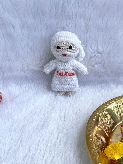 A serene doll of Sai Baba, dressed in all white with "Sai Ram" embroidered on his robe. These dolls bring a sense of peace and make a thoughtful gift for devotees.