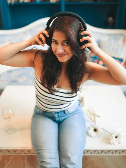 A fun and playful shot using headphones as a prop. This kind of portrait is great for showing personality and creating a relatable, candid moment.