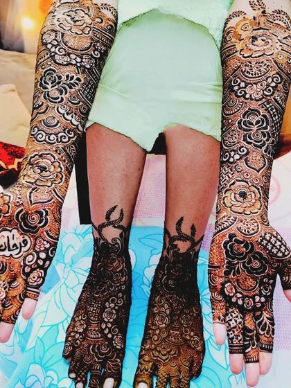 A full bridal look for Farheen, with matching intricate designs on her hands and feet.