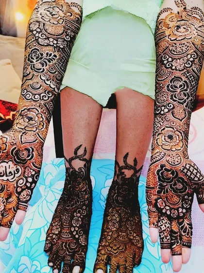 A full bridal look for Farheen, with matching intricate designs on her hands and feet.