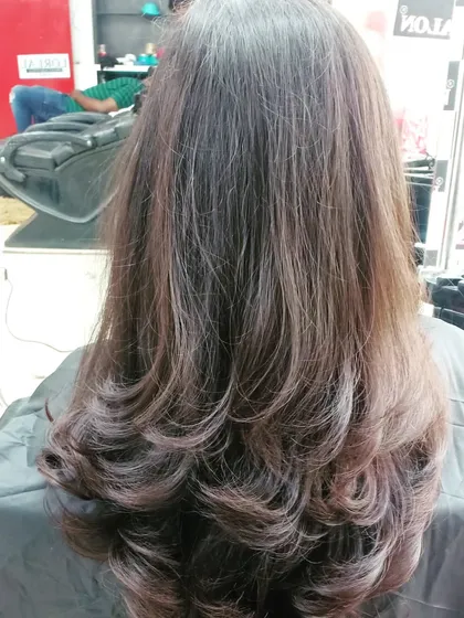 A simple yet elegant layered cut. The soft layers add texture and shape, making the hair look healthy and full.