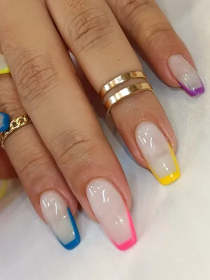 Why choose one color when you can have them all? This fun set features a classic French manicure base with a different vibrant neon color on each tip.