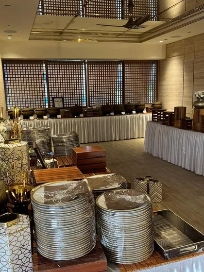 Another angle of a large buffet setup before an event. The stacks of plates, wooden risers, and floral arrangements are all part of the visual landscape I create.