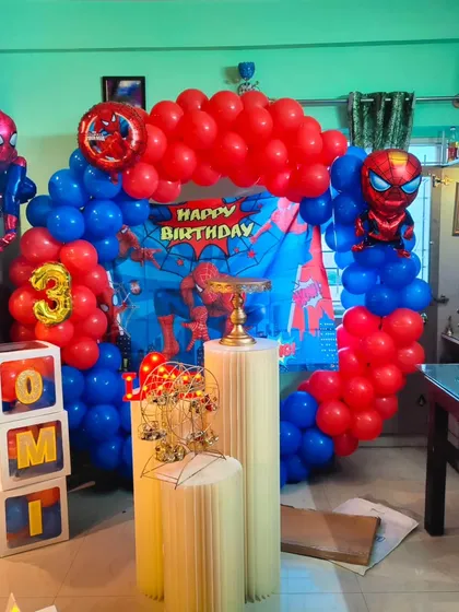 I bring popular kids' characters to life, like this complete Spiderman birthday party setup. It features a vibrant red and blue balloon arch, a themed backdrop, large Spiderman character balloons, and custom name blocks for the birthday boy.