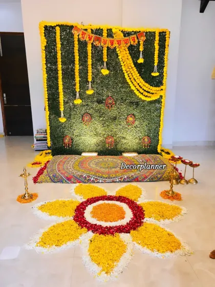 A closer look at the seating area for the Annaprashan puja. The colorful mattress and brass lamps complete the traditional look, ensuring every element is in harmony.