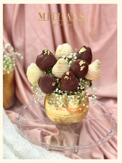 A beautiful bouquet of strawberries dipped in white and dark chocolate, presented in a golden vase. It is the perfect romantic gesture for Valentine's Day or any day you want to show your love.