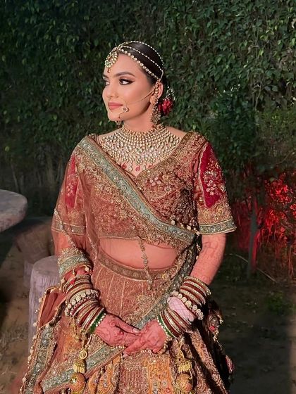 A royal bridal look in a unique color palette. Srishti's makeup was kept classic and elegant to balance her richly detailed lehenga.