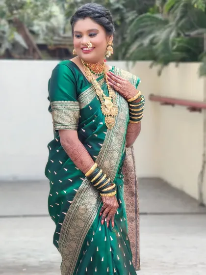 A full shot of my beautiful Maharashtrian bride Sandhya in a traditional green saree. The makeup is kept classic and radiant to complement her temple jewelry.