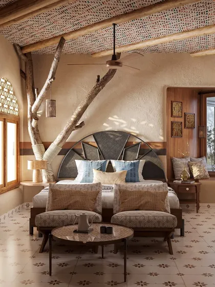 My design philosophy is rooted in bringing nature indoors. In this guest room, a preserved tree branch becomes a central feature, complemented by a custom headboard and locally inspired textiles on the ceiling, creating a space that is both rustic and refined.
