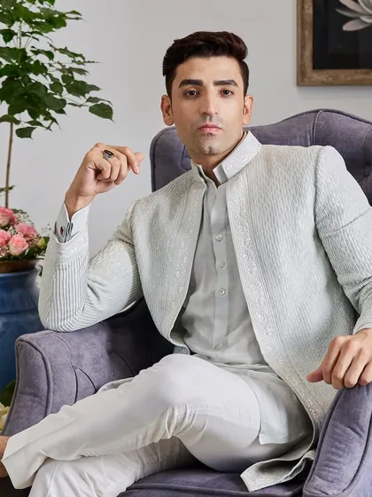 The complete look, paired with crisp white trousers, is perfect for a destination wedding or a summer evening event. It’s a sophisticated blend of comfort and high fashion.