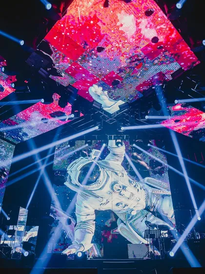 A close-up of the astronaut projection on a massive LED screen, surrounded by dynamic blue laser lights. This high-tech setup was central to our 'Infinity and Beyond' party theme.