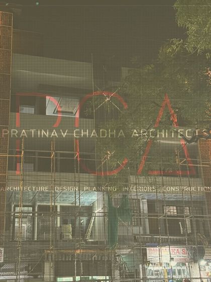 A progress shot of the Outram Lines residence facade, with scaffolding still in place. The lit terracotta jaalis offer a glimpse of the final, vibrant design.