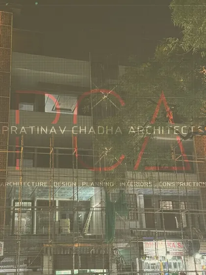 A progress shot of the Outram Lines residence facade, with scaffolding still in place. The lit terracotta jaalis offer a glimpse of the final, vibrant design.