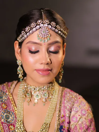 A close-up of a pastel bride. The soft pink eyeshadow and nude lip create a dreamy and romantic feel.