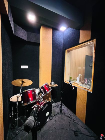 Another view of our drum booth, showing the professional setup with a window into the main studio, allowing for easy communication with instructors or bandmates.
