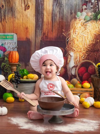 A cheeky little chef. Her playful expression and the vibrant farmer's market backdrop make for an adorable and lively portrait.
