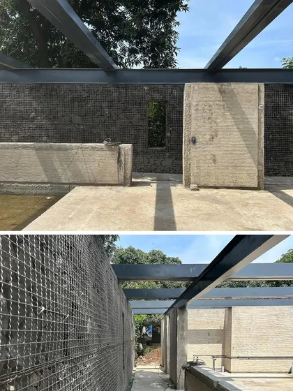 Progress at our Karjat residence, showing the construction of gabion walls filled with local stone. This technique provides structural support while creating a permeable, textured surface that integrates with the landscape.