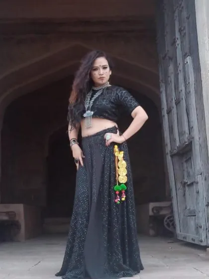 A full-length shot of the singer's 'Jogan' outfit. The addition of colorful tassels (parandi) to the lehenga added a touch of folk detail to the otherwise dark and glamorous look.