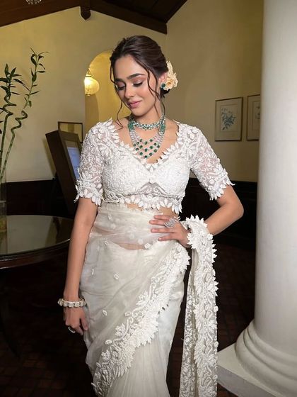 A full-length shot of the white lace saree, highlighting its delicate texture and modern appeal.