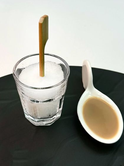 We love to deconstruct familiar concepts. Here, our Amarula ki Chuski is presented as a sophisticated palate cleanser, a small spoonful of liqueur served alongside a granita, embodying our playful yet refined approach to dining.