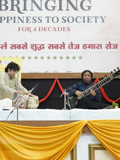 On stage with Ustad Shahid Parvez Khan Sahab in Bhopal. The simple stage setup allows the music to be the sole focus for the audience.
