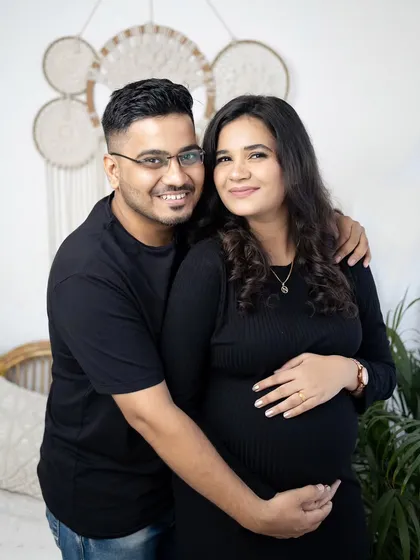 A classic couple's portrait from the indoor lifestyle session. They are posed comfortably together, looking at the camera with warm smiles.