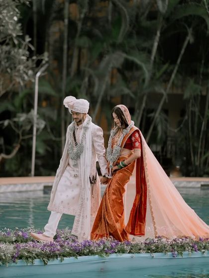 A unique wedding walk across the pool. The bride's flowing dupatta and the groom's steady hand create a magical, cinematic moment.