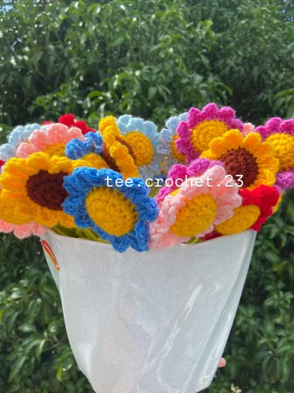A mixed bouquet of stuffed daisies and sunflowers, wrapped and ready for gifting.