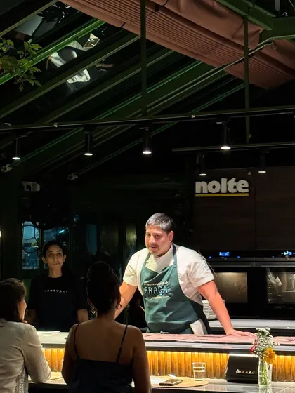 Chef Ralph Prazeres interacting with guests seated at the counter, sharing stories behind each dish. This direct engagement is a core part of the experience I curate.