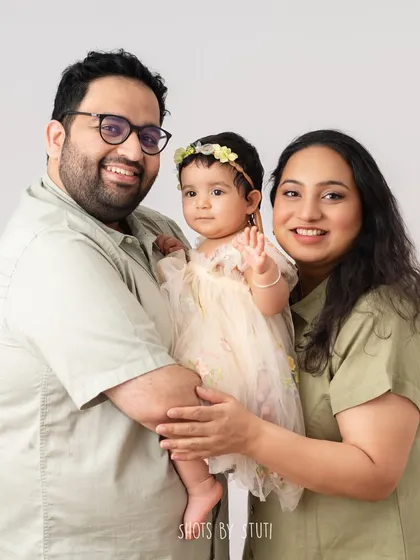 A perfect family portrait with a little wave from the star of the show. These are the classic, happy photos that look beautiful on any wall.
