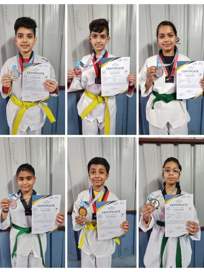 My male students displaying their medals after a successful run at the 11th Winter Cup Taekwondo Championship.