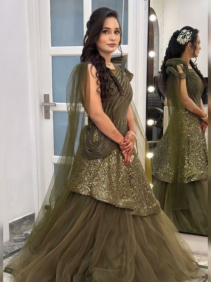 A stunning engagement look in an olive green peplum gown. The makeup is glamorous with defined eyes, and the hair is styled in soft waves.