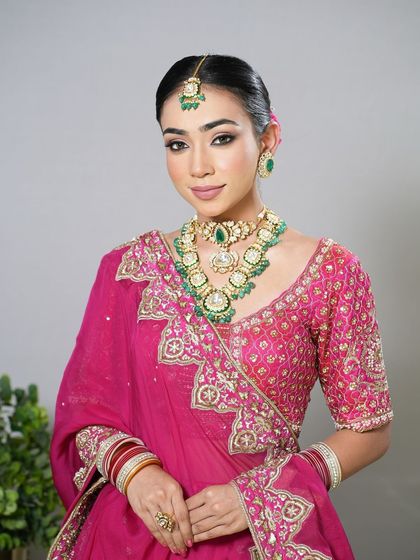 A classic bridal portrait with a sleek bun and floral details.