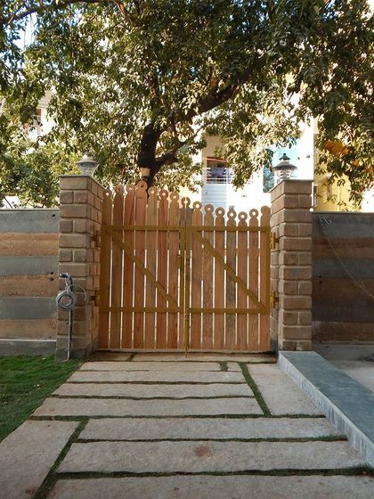 The symmetrical design of this gate and walkway provides a sense of formal order and welcome.