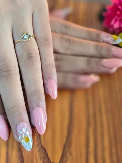 A beautiful soft pink set with a delicate floral accent nail, created by my student Prajakta.