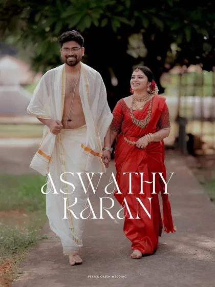 An elegant portrait of the couple walking hand-in-hand after their temple wedding, their traditional red and white attire looking timeless.