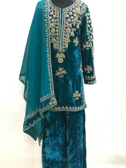 A full-length view of the custom teal velvet suit, showing the matching palazzo pants.