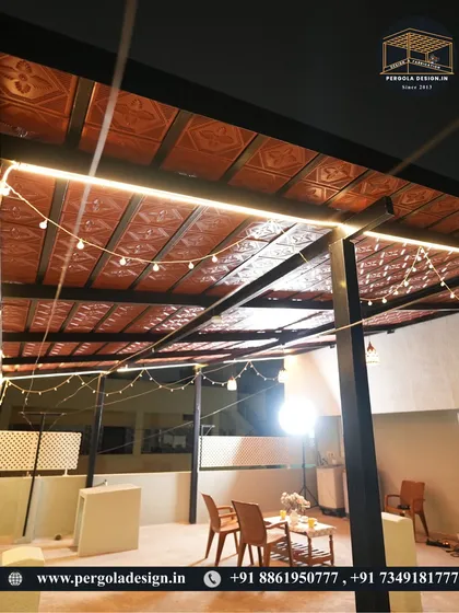 This wide shot shows the full expanse of the tiled rooftop pergola at night. The space is set up for a small gathering, demonstrating its potential as a versatile outdoor entertainment area.