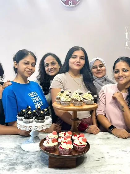 A proud group of students with their cupcake creations. The class covered a variety of styles, from elegant floral designs to rich and decadent chocolate cupcakes.