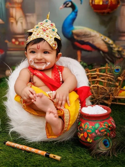 A happy baby Krishna with a face full of 'makhan', advertising the fun of my Janmashtami sessions for all ages.